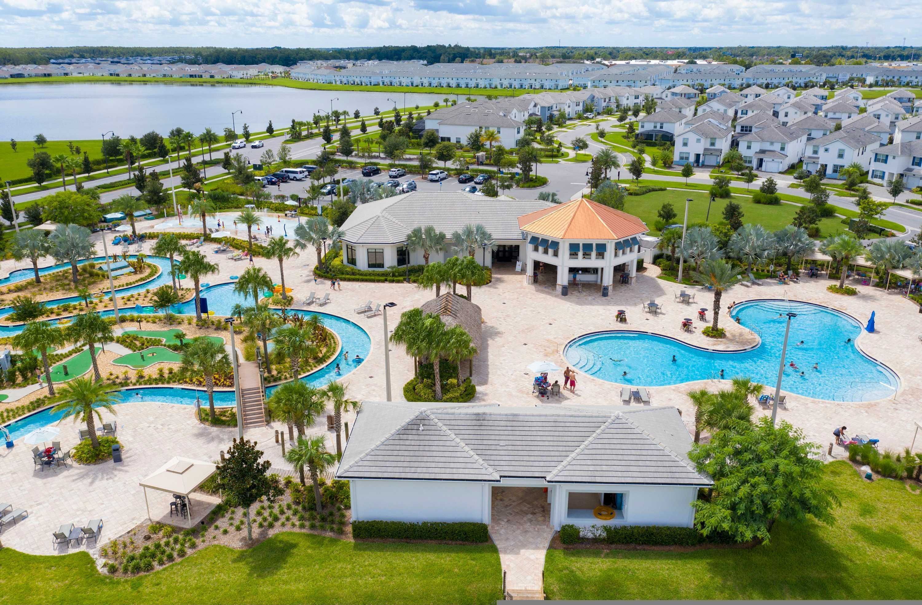 A resort with multiple swimming pools, a golf course, and a large building with a dome roof.