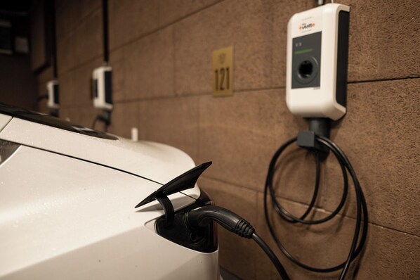 A car charging at a station with a visible wall number 121. - Berghotel Kleiner Biber (Warth)