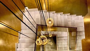 Una moderna scala con finiture metalliche ed elementi dal design geometrico.