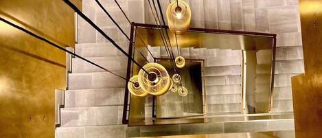 A modern staircase with a metallic finish and geometric design elements.