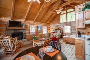 A cozy cabin interior with a dining area, kitchen, and living space. - View  Private Studio Cabin Hot Tub RELAX Honeymoon (Sevierville)