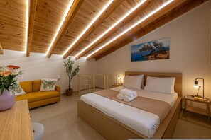 A modern bedroom with a wooden ceiling, a bed with white linens, a yellow sofa, and a painting on the wall. - Home Easy Kalamata - Central Stylish Maisonette (Kalamata)
