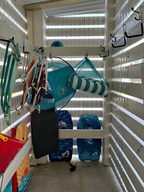 A room with bunk beds, a hanging hammock, and various bags and equipment. - Whimsical Way- Beach Access  Pool  built in 2025 (Gulf Shores)