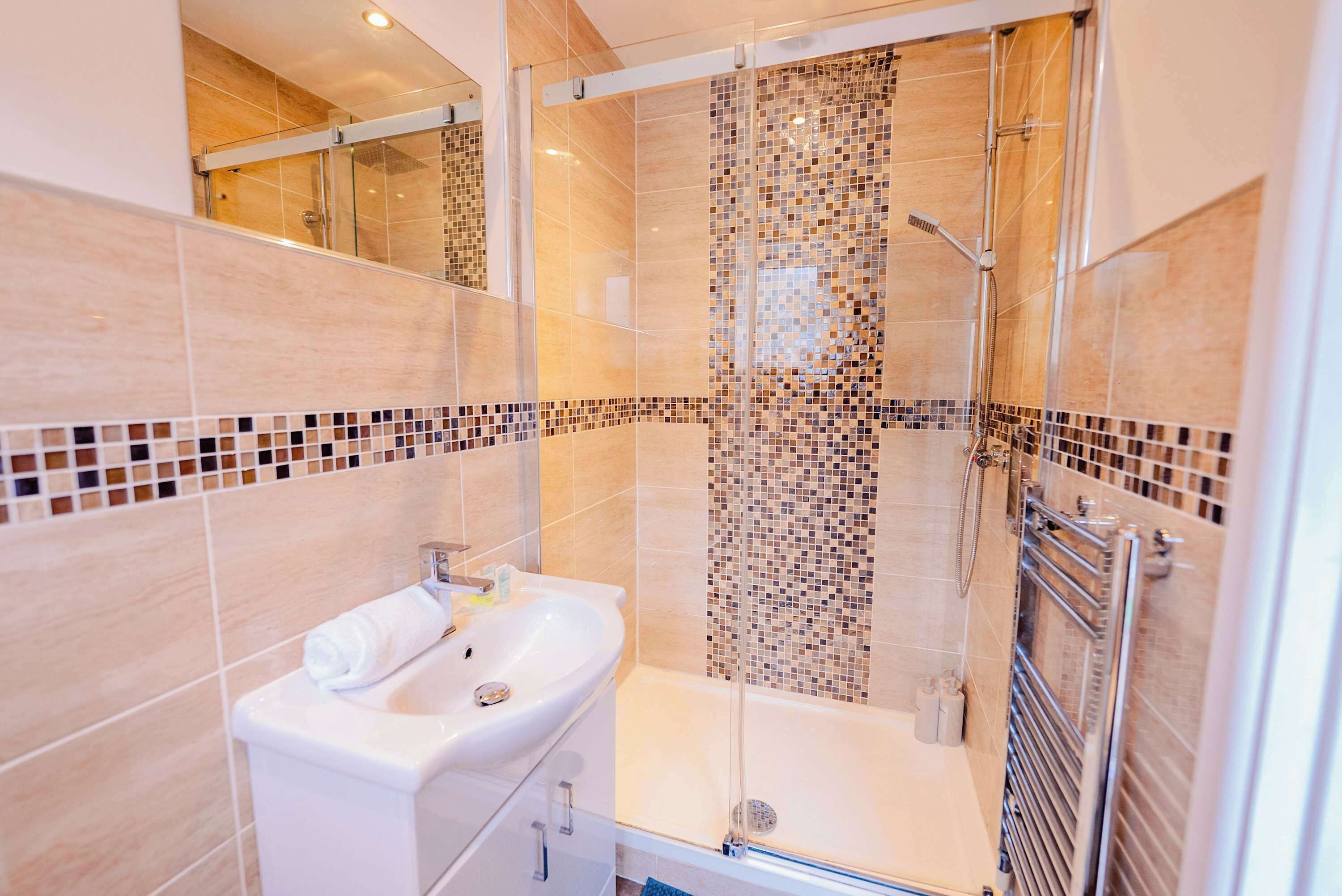 Shower, hair dryer, towels, shampoo