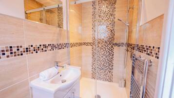 Shower, hair dryer, towels, shampoo