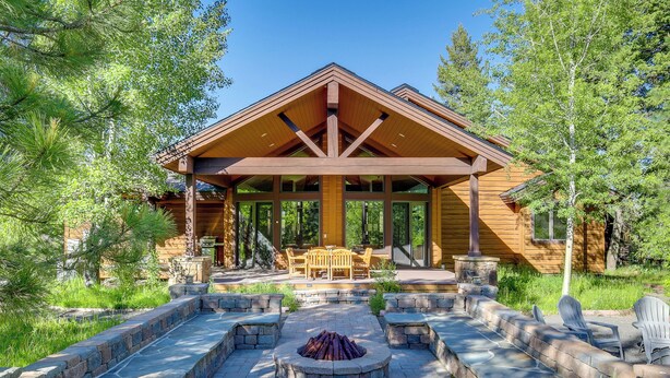 A log cabin with a stone fire pit, outdoor seating, and a covered patio. - Ski-in/ski-out! Mtn-view Donnelly Home w/ Hot Tub (Donnelly)