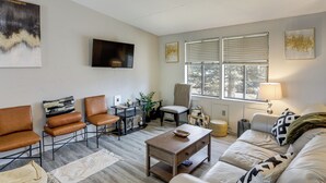 A modern living room with a sofa, chairs, a coffee table, and a TV. - 6 Mi to Dtwn Toledo! Family-friendly Haven w/ Deck (Toledo)