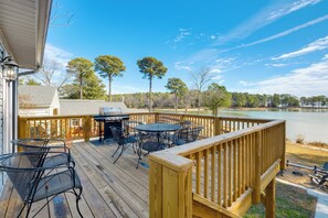 A wooden deck with outdoor furniture, a grill, and a view of a lake. - Waterfront Gem w/ Deck & Views on Chesapeake Bay! (Reedville)