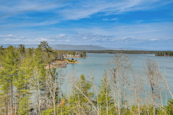 A lakeside view with trees, a dock, and a small building. - Steps to Private Beach! Family Home on Lake James (Morganton)