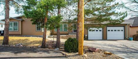 A residential area with houses, a driveway, and a utility pole.