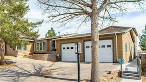 A single-story house with a garage, a front yard with a tree, and a sidewalk leading to the entrance. - Mountain Basecamp Near Red Rocks (Golden)