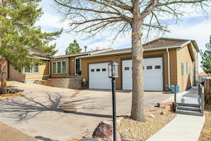 A single-story house with a garage, a front yard with a tree, and a sidewalk leading to the entrance. - Mountain Basecamp Near Red Rocks (Golden)