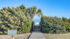 A wooden pathway leading to a beach with a 'Private Property No Trespassing' sign. - Golden Mile Getaway Steps From the Beach (Myrtle Beach)