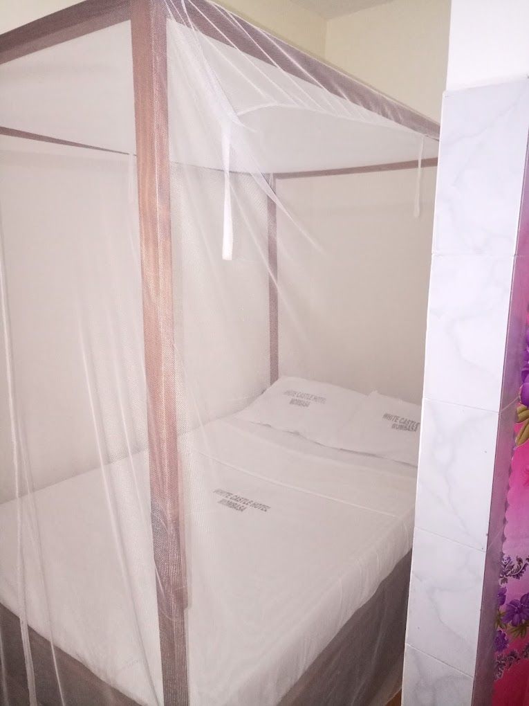 A four-poster bed with a mosquito net.