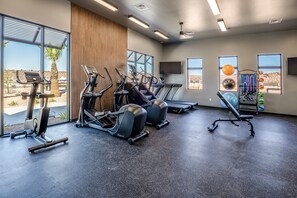 A gym with treadmills, a rowing machine, and a weight bench. - Isle Be Back 6 Bedroom Townhouse (Washington)