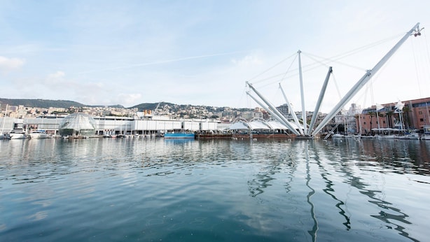 A waterfront view with a distinctive white cable-stayed bridge, calm water, and a cityscape in the background. - Apartment 'Casa Luna' Opposite Genoa Aquarium (Genova)
