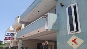 A two-story building with a 'Rooms Available' sign, a gated entrance, and a 'Sofitel' logo. - The K Inn Wavefront (Tirukalukundram)