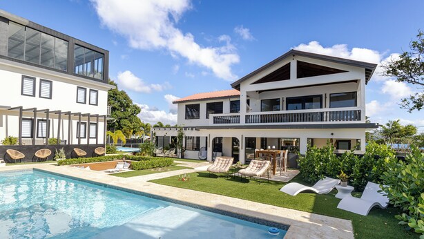 A modern two-story house with a swimming pool, outdoor seating, and a well-maintained garden. - 623 Boquerón Villas (Boquerón)