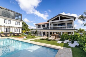 A modern two-story house with a swimming pool, outdoor seating, and a well-maintained garden. - 623 Boquerón Villas (Boquerón)