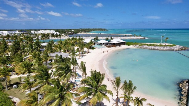 A beach resort with multiple pools, palm trees, and a sandy beach. - Villa Monica: Private retreat near golf w/ staff, pool & golf cart (Punta Cana)