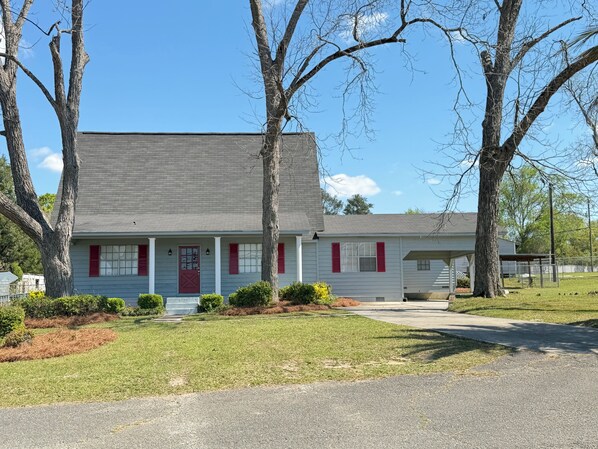 A single-story house with a front porch, a garage, and a well-maintained lawn.
