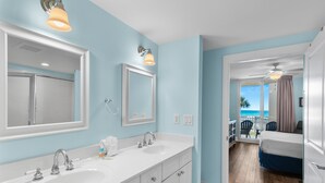 A bathroom with two sinks, a mirror, and a shower. - 🌊Lazy River | Lagoon Pool + Splash Pad | Walk to Beach | Waterscape 205B⛱️ (Fort Walton Beach)