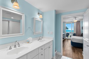 A bathroom with two sinks, a mirror, and a shower. - 🌊Lazy River | Lagoon Pool + Splash Pad | Walk to Beach | Waterscape 205B⛱️ (Fort Walton Beach)