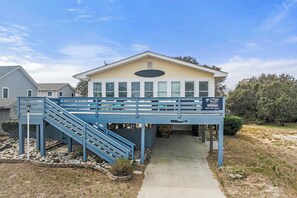 A two-story house with a blue staircase leading to a covered porch. - Good Times Wright Place: Dog-Friendly | YMCA Access (Kill Devil Hills)