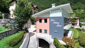 A multi-story building with a sign reading "Your Holiday Home." - A 5 minuti dal Lago di Tenno, spaziosa villa con piscina vista Lago di Garda (Trentino-Alto Adige)