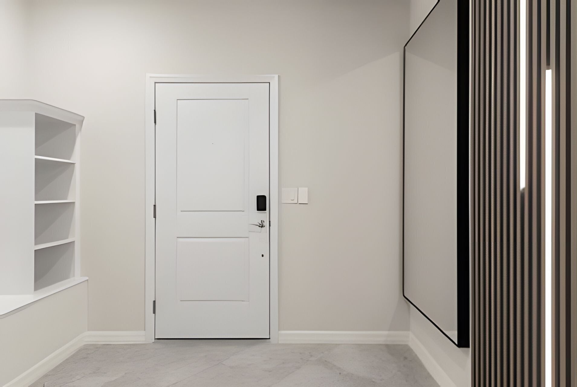 Un couloir avec une porte blanche, une étagère blanche et un grand panneau vertical sur le mur de droite.
