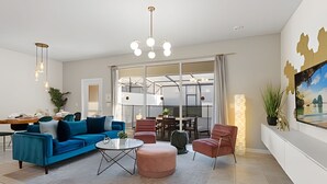 Een moderne woonkamer met een blauwe bank, een ronde salontafel en een rode fauteuil. Er is een groot raam met uitzicht op een stadsbeeld.