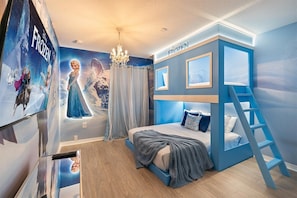 A bedroom with a bunk bed, a mural of Frozen characters, a chandelier, and a ladder to the bunk bed. - 4 Bd / 3 Ba / Sleeps 11/ Storey Lake Resort (Kissimmee)