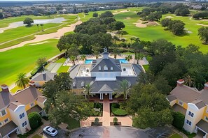 A golf course with a clubhouse and residential buildings. - 5 Bd / 5 Ba / Sleeps 14 / Reunion Village (Kissimmee)