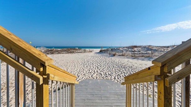 A wooden staircase leading to a sandy beach with a clear sky. - ✨Beachfront Complex + Community Pool | Sleeps 4 | Sunrise Village 111✨ (Gulf Shores)
