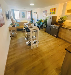 A compact living space with a dining area, kitchen, and seating area. - Mirepoix 4 star apartment (Mirepoix)