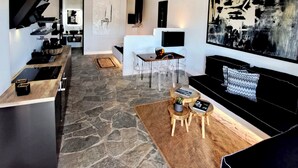 A modern living space with a kitchen, dining area, and seating area. - Mykonos Dot Art Homes - Premium Home One (Ano Mera)