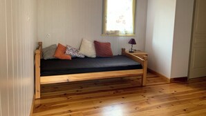 A small, cozy room with a wooden bed, a nightstand, and a window with a view. - Le soleil d'eau 3 villa with terrace, parking (Meyras)