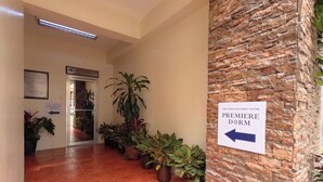 A hallway with a sign indicating the direction to the Premiere Dorm. - The Luneta Seafarers Center Premier Dorm (Manila)