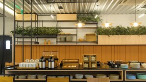 Ein Restaurantinneres mit Theke, Regalen und Sitzbereich.