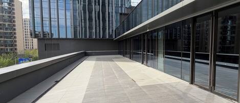 A modern building with large glass windows and a tiled floor.