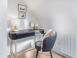 A modern room with a desk, chair, lamp, and framed pictures on the wall. - Rosamund Townhouse Clifden (Clifden)