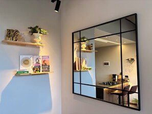 A modern room with a large mirror, bookshelves, and a coffee bar. - Luxury and Modern apartment in El Poblado/AC/Alexa (Medellín)