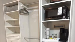 A compact kitchen with a built-in refrigerator, a microwave, and a coffee machine on the countertop. - Private Suite w/ Bath & Free Parking (Brockton)