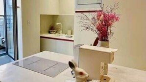 A bathroom with a sink, mirror, and a vase with pink flowers. - "Rose" Atypical Cocoon in the Heart of the Upper Quarter (Sète)