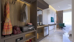 Una habitación de hotel moderna con un armario de madera, una zona de estar con una silla verde, un televisor y un piso de mármol.
