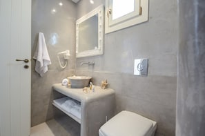 A modern bathroom with a vanity, sink, mirror, and toilet. - My Villa Naxos I (Naxos)