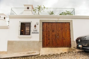A building with a large wooden door, a small window with a metal grill, and a sign above the door that reads "Las Marías". - *Beautiful Colonial House* next to Antigua Guatema (Antigua)