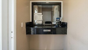 A hotel reception area with a 'No Smoking' sign, a reception desk, a computer, and a door in the background. - Golden Motel Near Houston Medical Center (Houston)