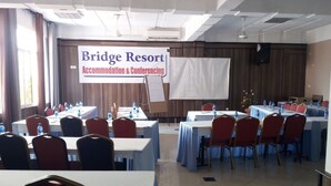 A conference room at Bridge Resort with tables and chairs arranged for meetings. - Bridge Hotel Mombasa (Mombasa)