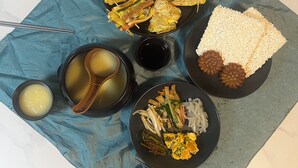 A meal with various dishes, including fried items, rice, and soup, served on a blue tablecloth. - Dodahm Guesthouse (Incheon)